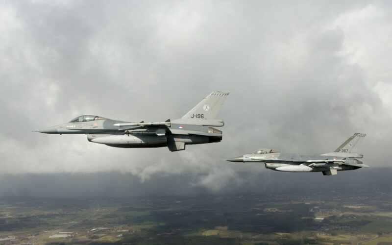 Two Dutch F-16 fighter jets flying in formation