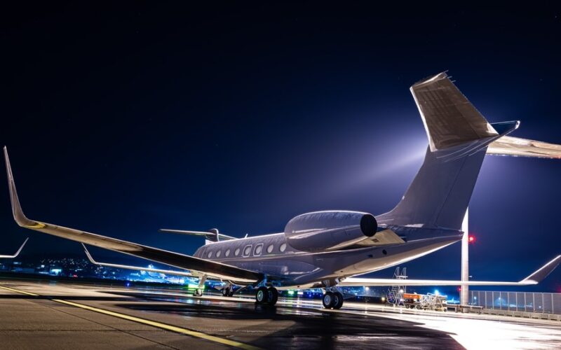 Business jet parked at night