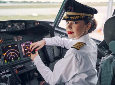 Lady pilot posing for the camera in the cockpit