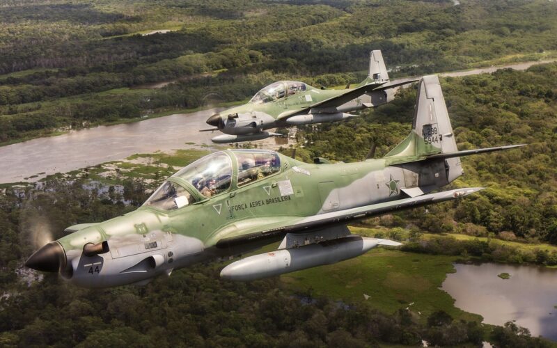 Brazilian Air Force Embraer A-29 Super Tucano aircraft in flight over the Amazon Rainforest