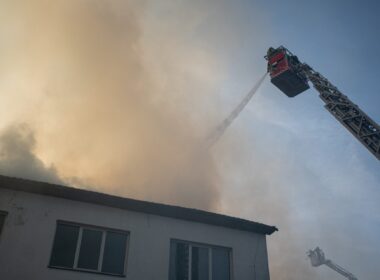 Firefighters using aerial equipment to battle a massive fire