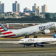 American Airlines Boeing 777 taking off from John F Kennedy International Airport with the jetBlue Airbus A320 taxing behind it