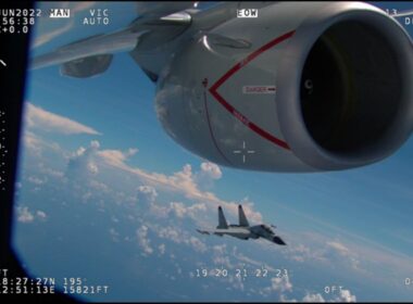 A Chinese fighter flying close to the nacelle of a US aircraft