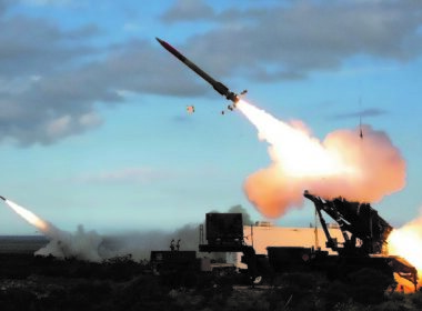 A Patriot air defense system firing two missiles