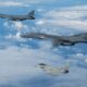 A Royal Air Force Typhoon fighter jet flying with two U.S. Air Force B-1B bombers