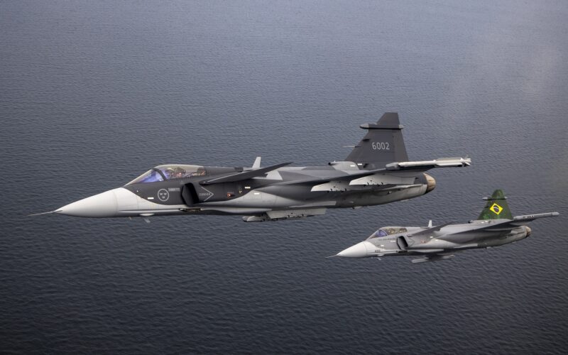 A Sweden and a Brazilian Gripen fighters flying in formation