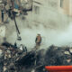 A firefighter standing in the ruins of a residential building in Dnipro