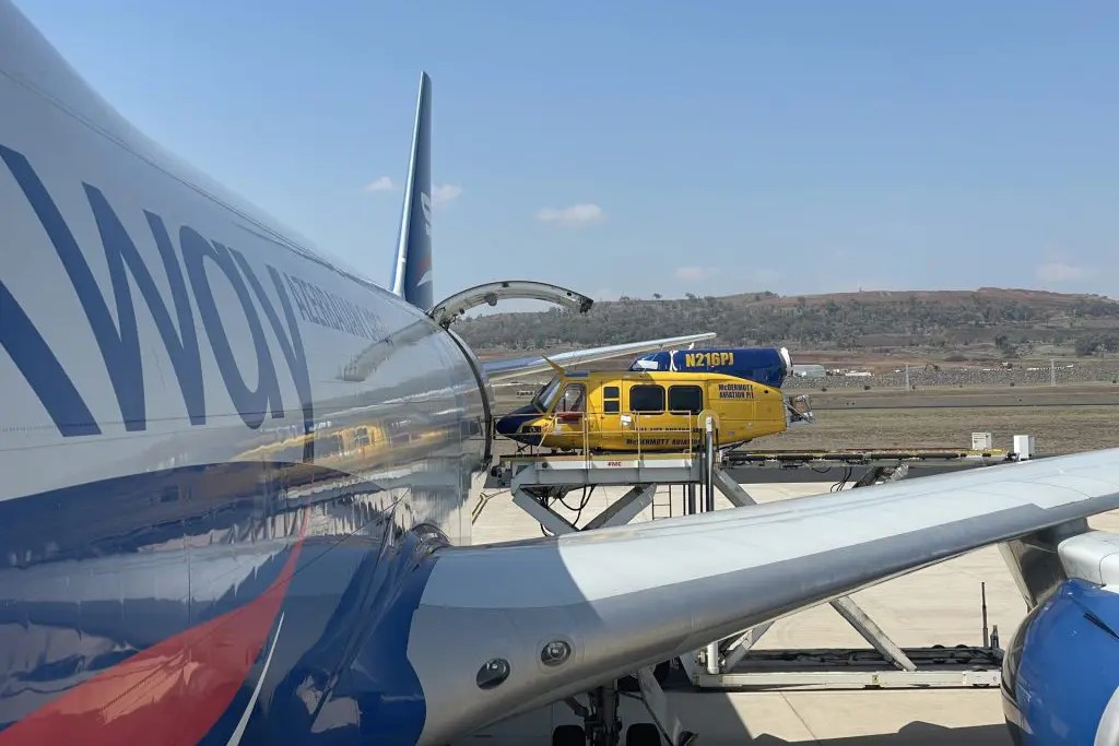 Bell helicopter being lifted into a Boeing 747