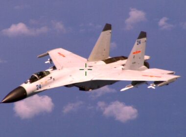 140819-N-ZZ999-113 WASHINGTON (Aug. 19, 2014) An armed Chinese fighter jet flies near a U.S. Navy P-8 Poseidon patrol aircraft over the South China Sea about 135 miles east of Hainan Island in international airspace. (U.S. Navy Photo/Released)