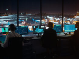 Diverse Air Traffic Control Team Working in Modern Airport Tower at Night