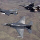 F 16 advanced fighter jet flying in formation with other F 16s and fighter jets