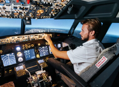 First officer is controlling autopilot and parameters for safety flight. Cockpit of Boeing aircraft.