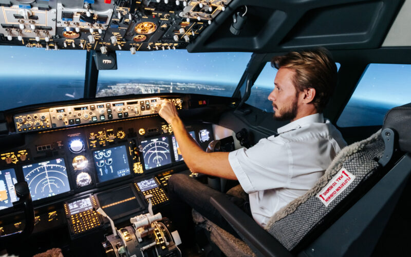 First officer is controlling autopilot and parameters for safety flight Cockpit of Boeing aircraft