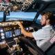 First officer is controlling autopilot and parameters for safety flight Cockpit of Boeing aircraft