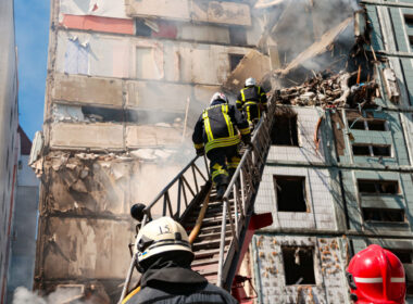 Rescuers at a residential building hit by a missile in Uman