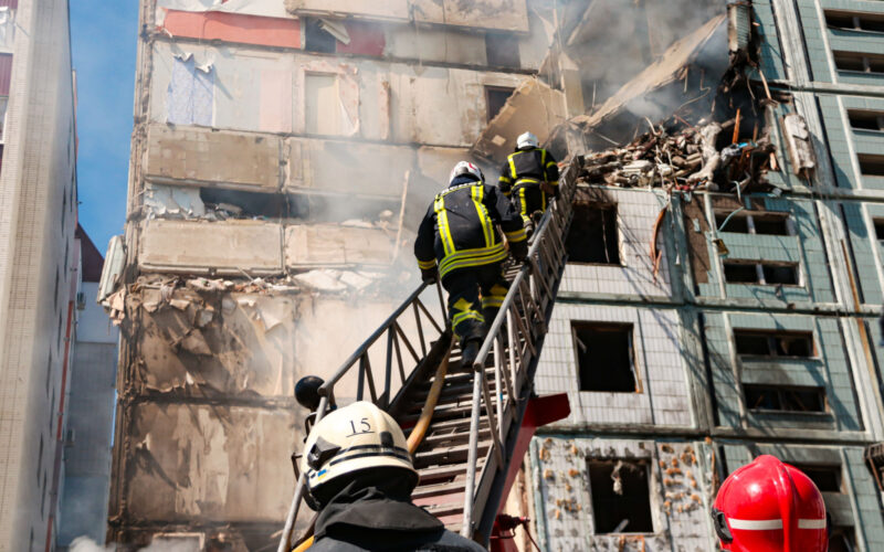 Rescuers at a residential building hit by a missile in Uman