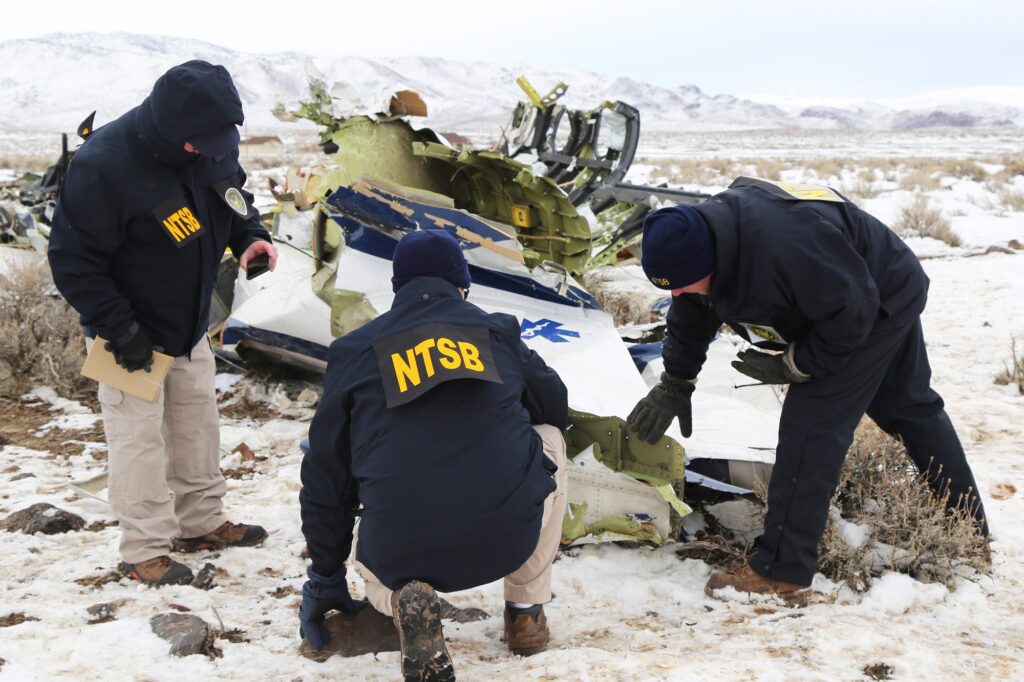 Investigators from National Transport Safety Board look over plane wreckage in Nevada after a Pilatus PC 12 airplane crashed