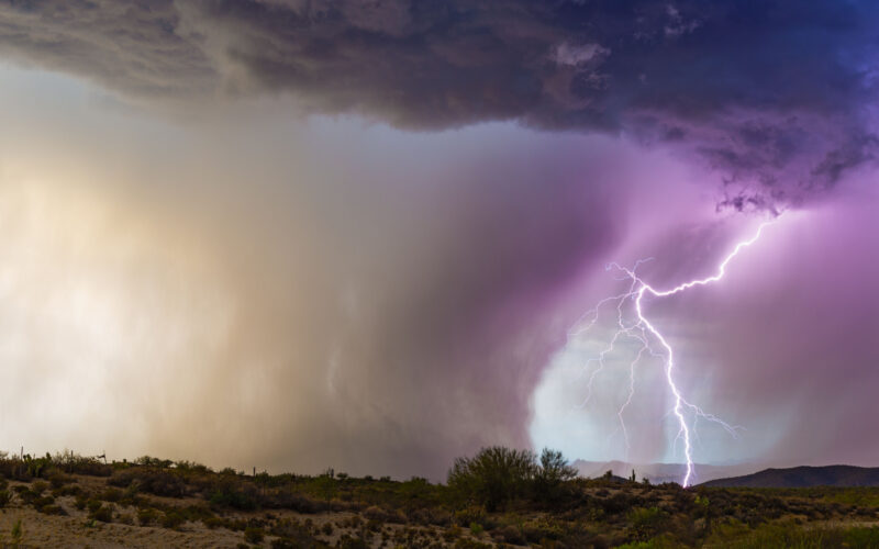 Lightning illuminates a microburst from a monsoon thunderstorm in the Arizona desert