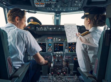 Pilot and female first officer seated in the flight deck