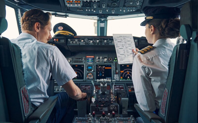 Pilot and female first officer seated in the flight deck