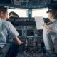 Pilot and female first officer seated in the flight deck