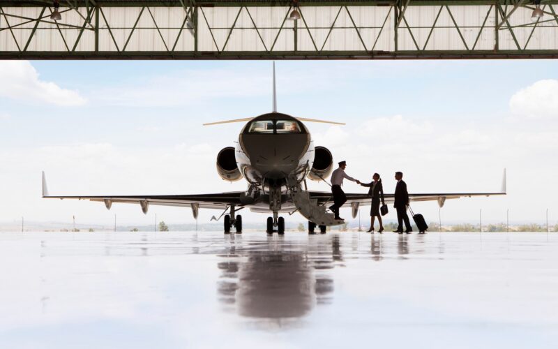 Silhouette,Of,Pilot,Greeting,Businessman,And,Businesswoman,Boarding,Private,Jet