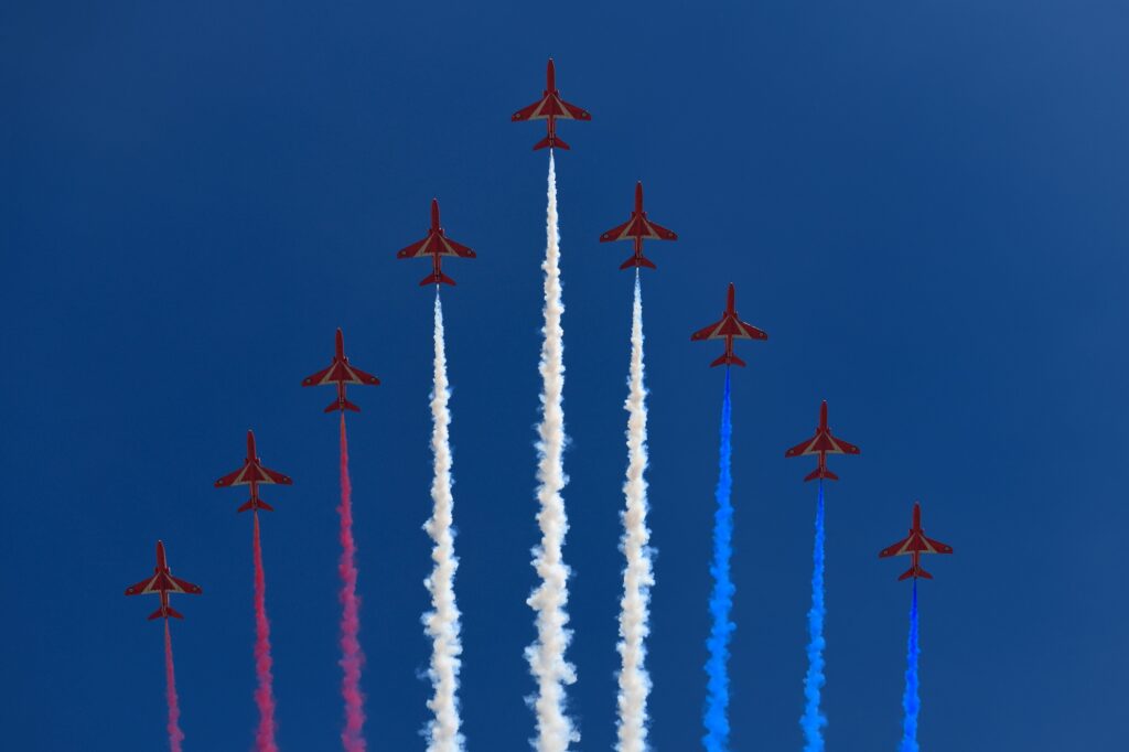 Formation of RAF Red Arrows with coloured trails on blue sky for flypast at Trooping the Colour for Queen Elizabeths 93rd birthday London England   June 8 2019