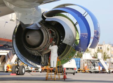 Technician checking engine of civil airliner.