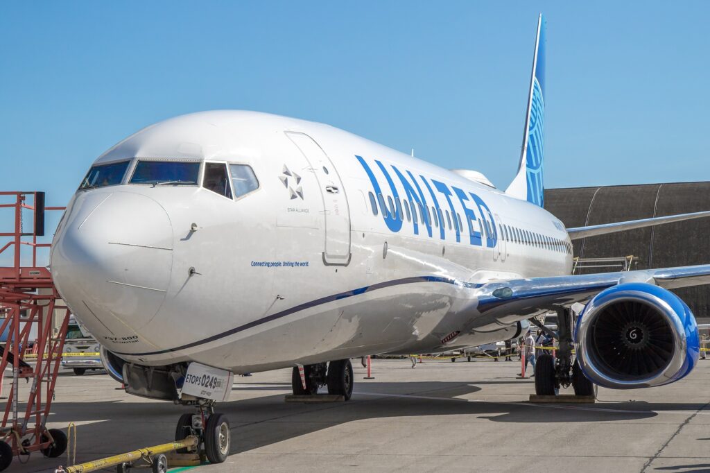 A United Airlines Boeing 737 900ER suffered significant damage to its fuselage following an American Airlines baggage cart hitting it at ORD