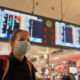 a_woman_with_a_mask_on_at_an_airport_covid-19.jpg