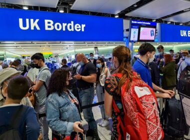 air_travelers_queuing_at_uk_border_control_in_heathrow_airport_london.jpg