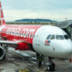 airasia_airbus_a320_family_aircraft_parked_in_kota_kinabalu_international_airport.jpg