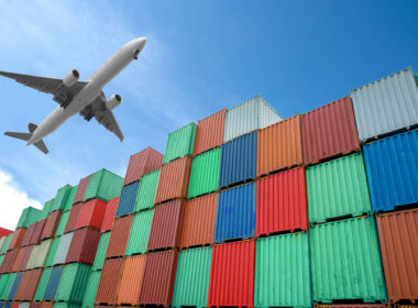 aircraft_flies_over_cargo_containers.jpg