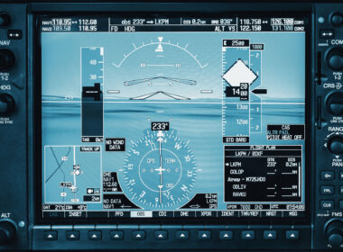 Computer in cockpit. Airplane glass cockpit display with weather radar and engine gauges in small private airplane