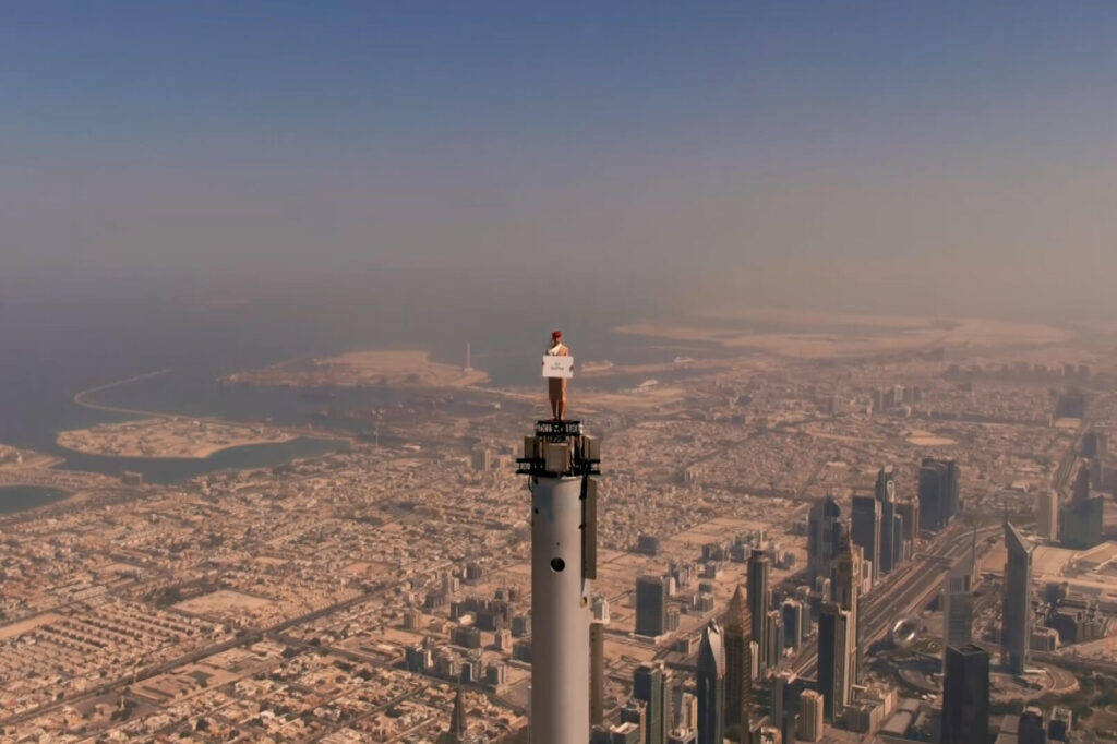 an_emirates_cabin_crew_stands_on_top_of_the_burj_khalifa.jpg