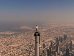 an_emirates_cabin_crew_stands_on_top_of_the_burj_khalifa.jpg