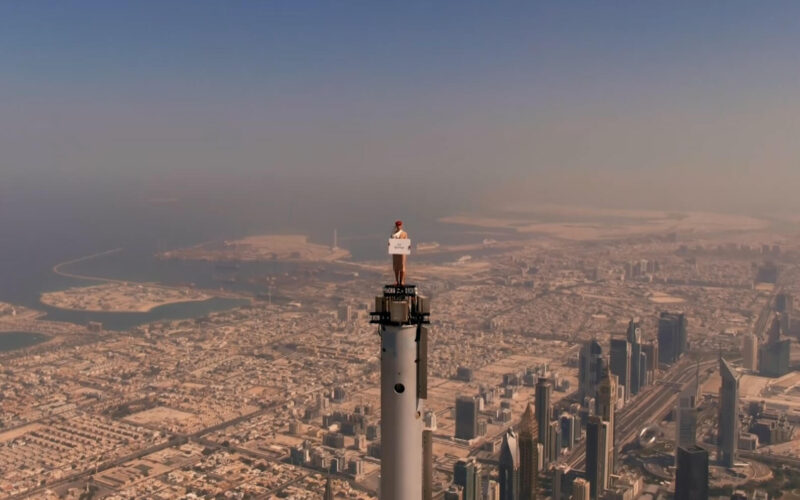 an_emirates_cabin_crew_stands_on_top_of_the_burj_khalifa.jpg