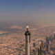 an_emirates_cabin_crew_stands_on_top_of_the_burj_khalifa.jpg