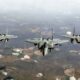 an_f-15ex_eagle_ii_flying_alongside_two_f-15c_fighters.jpg