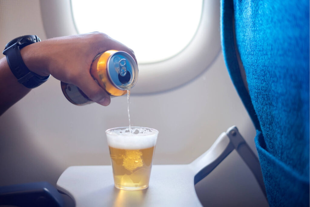 beer_being_poured_into_a_cup_onboard_a_plane.jpg