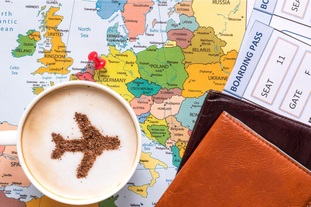 capuccino_passpord_and_a_boarding_pass_over_the_map_of_europe.jpg