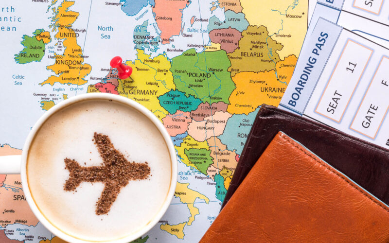 capuccino_passpord_and_a_boarding_pass_over_the_map_of_europe.jpg