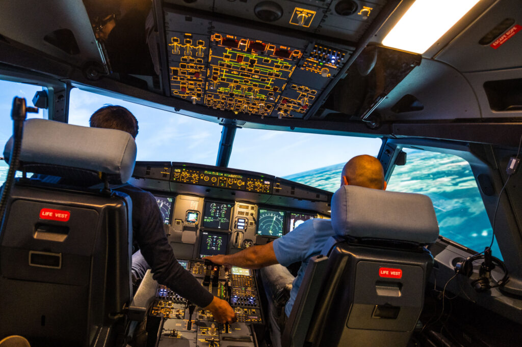 modern airbus airplane cockpit with pilots during a training session in a full flight simulator