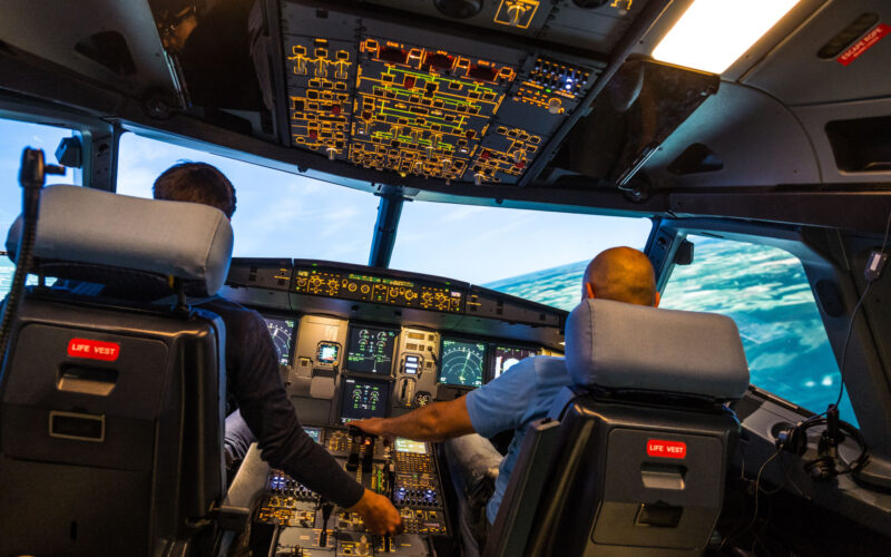 modern airbus airplane cockpit with pilots during a training session in a full flight simulator