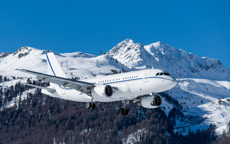 huge private jet airliners size arriving at the highest airport in europe with a beautiful mountain scenery in the background