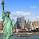 new york city skyline cityscape with statue of liberty over hudson river with midtown Manhattan skyscrapers and freight sailing ship in usa america