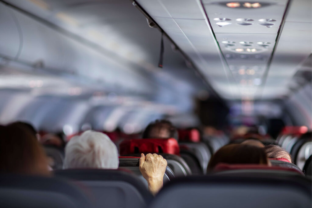 passengers_on_aircraft_holding_airplane_seat.jpg