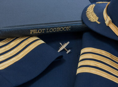 pilot_logbook_with_a_captains_hat_and_shoulder_sleeves_with_four_stripes.jpg