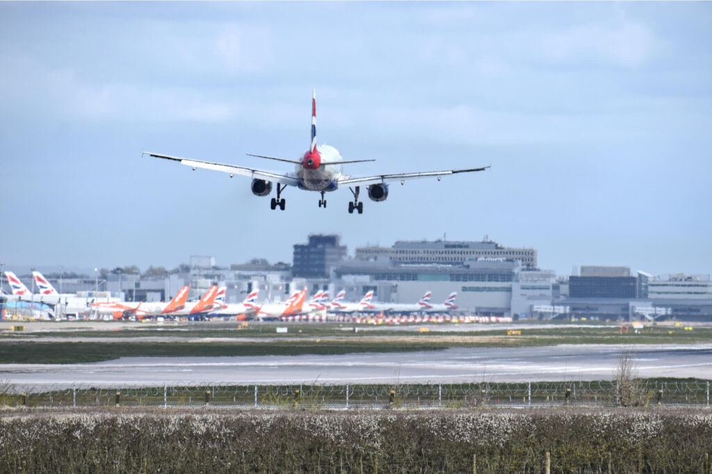 plane_landing_at_gatwick_against_backdrop_of_parked_planes.jpg