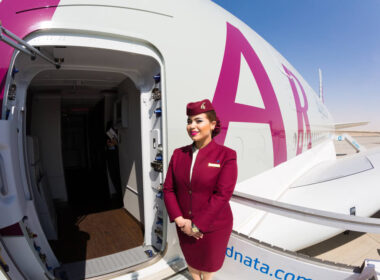 qatar_airways_flight_attendant_welcoming_passengers_on_board_an_airbus_a380-1.jpg